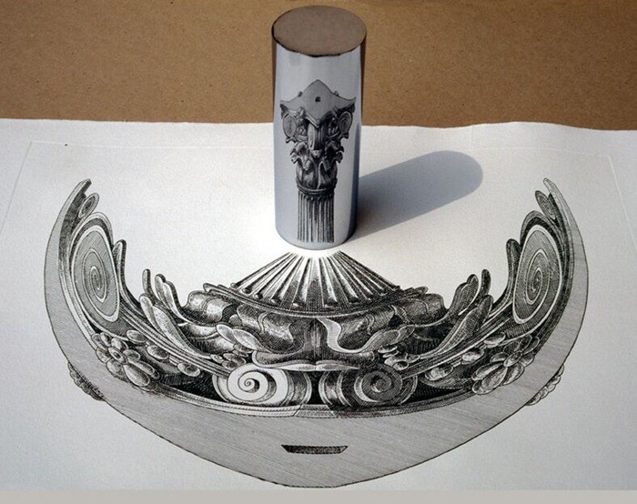 A reflective cylinder stands on a distorted decorative drawing and reconstructs the image in its curved reflection.