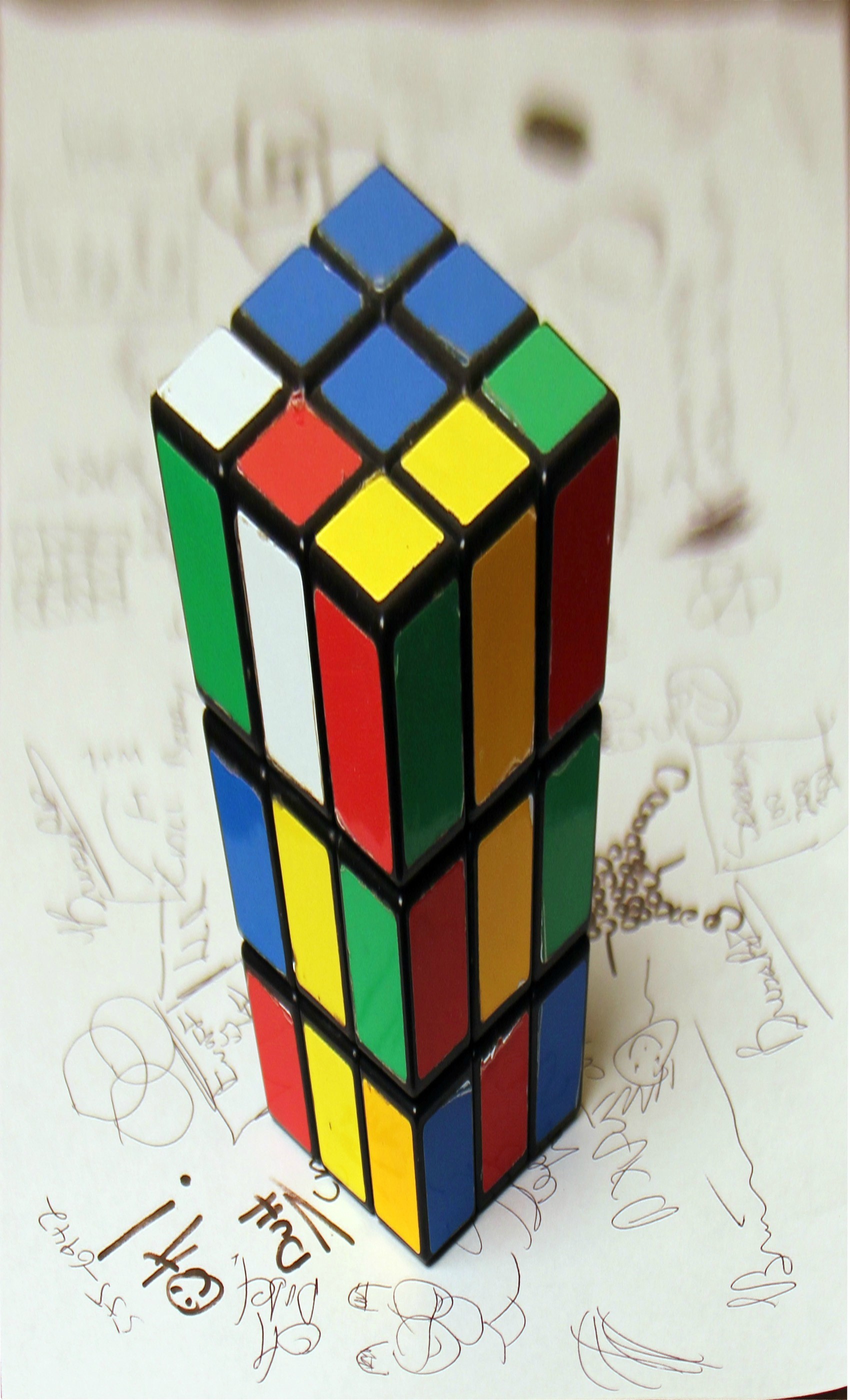 A multicoloured puzzle cube viewed so that its perspective makes the upper face appear to project upwards.