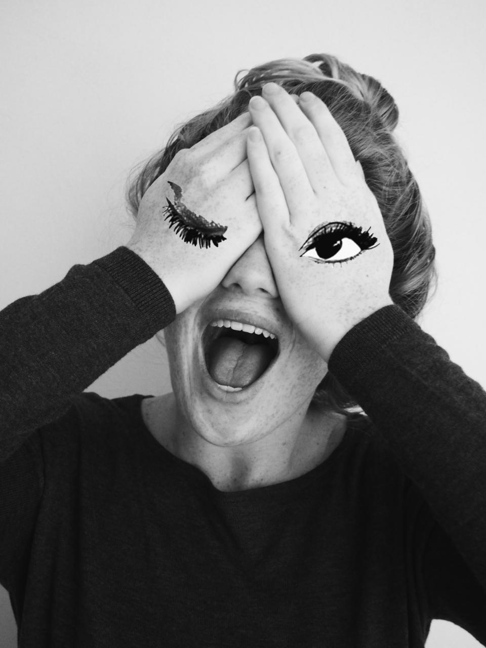 A black-and-white photograph of a woman holding her hands around her eyes and mouth, used in a positive afterimage demonstration.