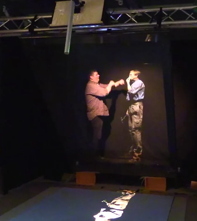A Pepper’s Ghost workshop display using a video screen and reflective glass.